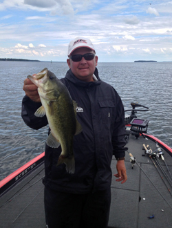 Kurt Dove holding a smallmouth bass at Lake Oneida