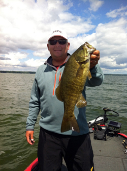 Kurt Dove holding a smallmouth bass on Lake Oneida, NY